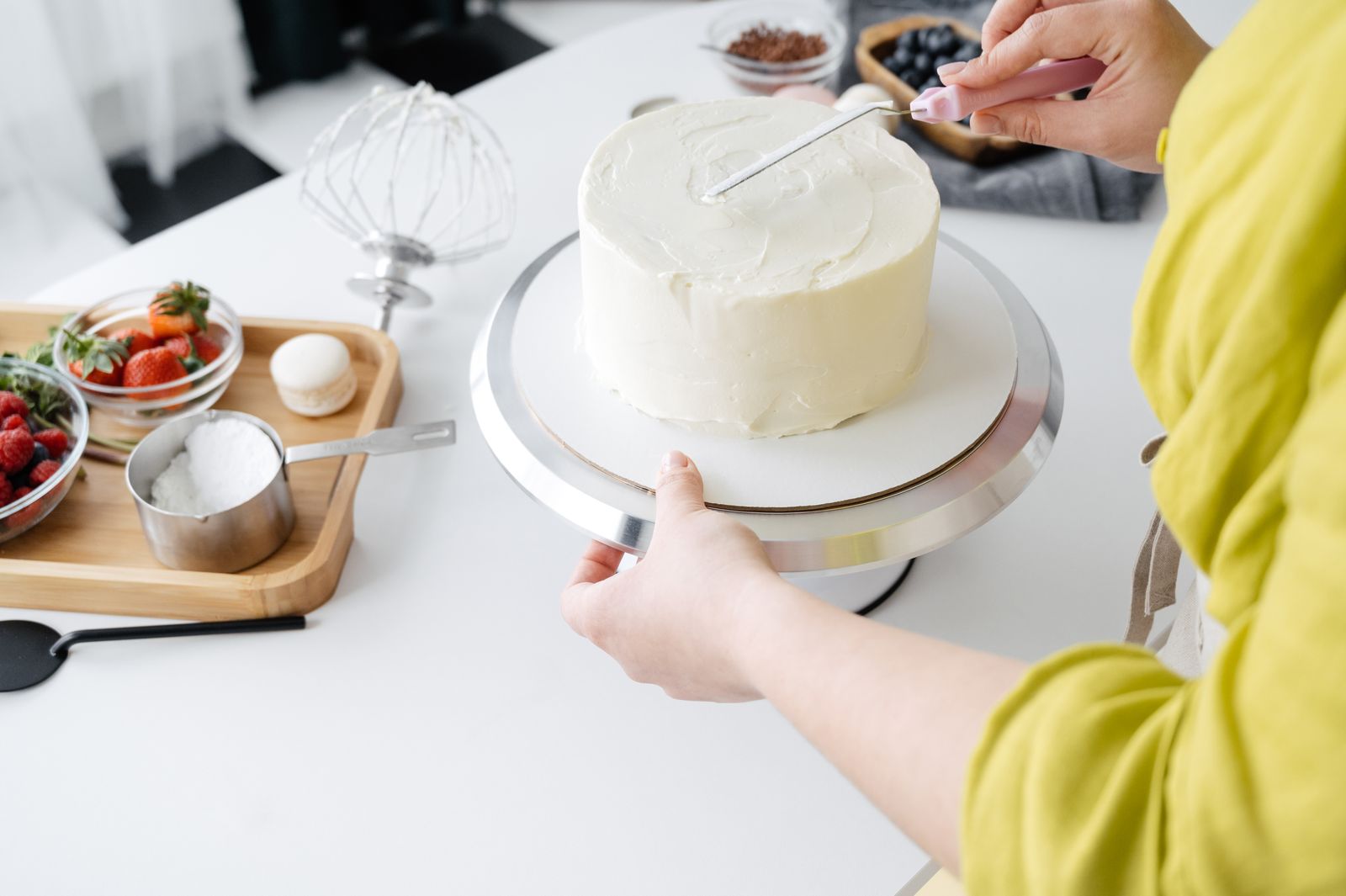 A baker decorating a cake